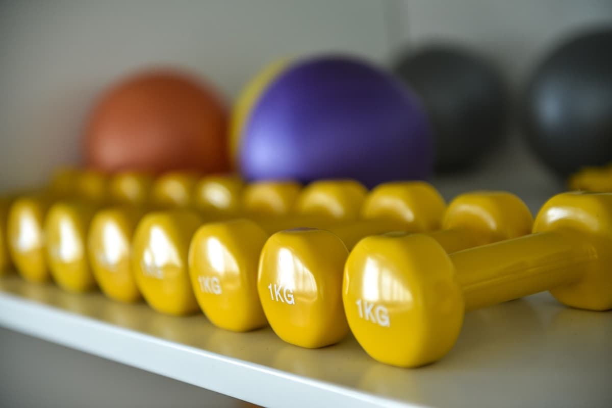 Row of dumbbells and Pilates balls used in Pilates Sculpt classes at Evolvere