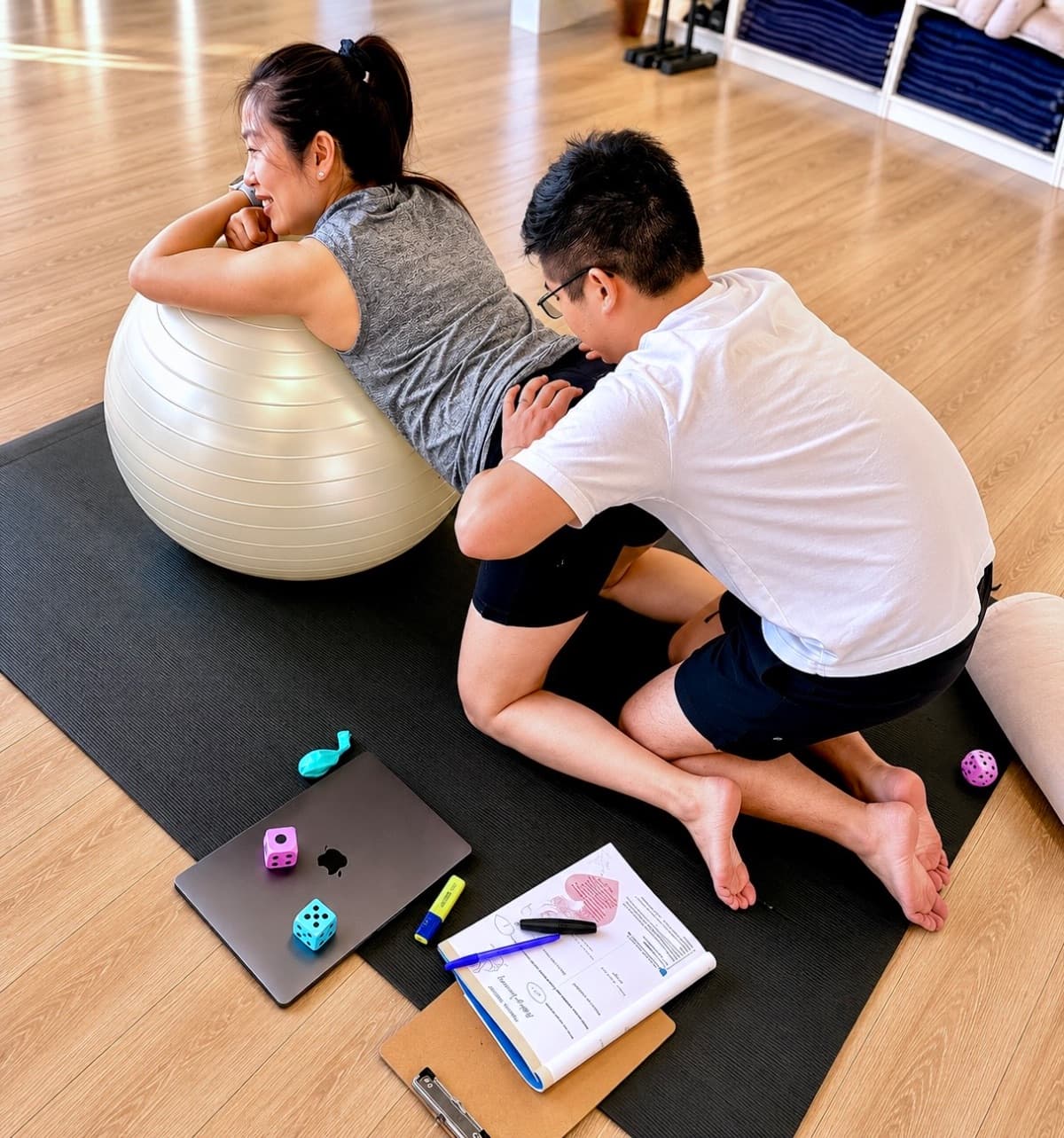 Couple practicing labour positions with a fitball during birth preparation