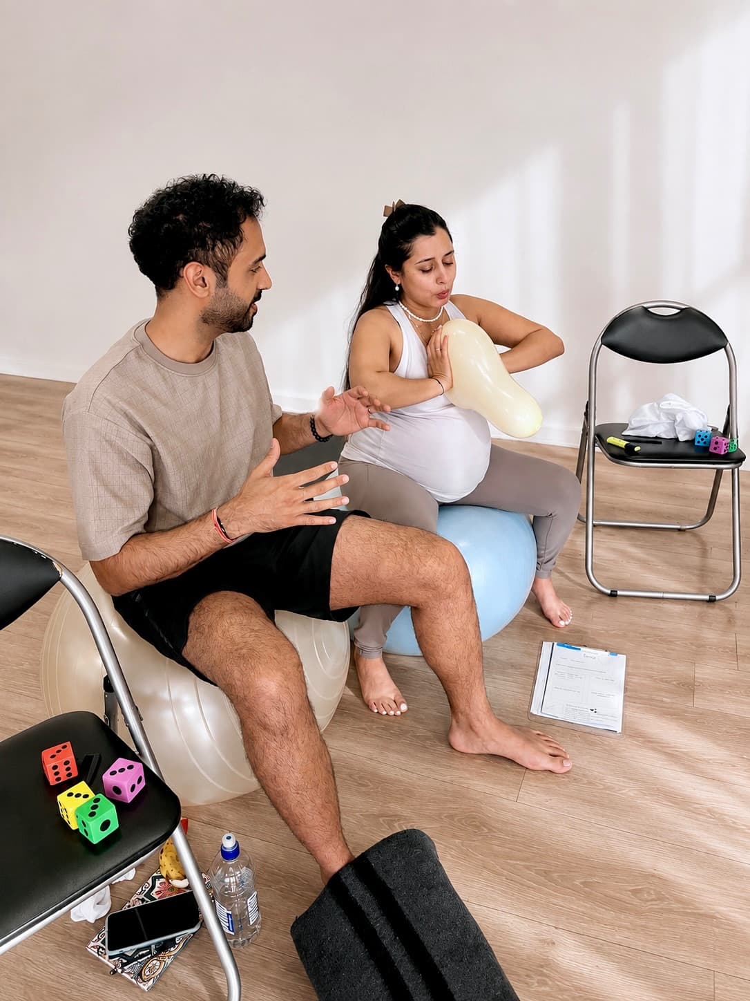 Couples practicing birth support techniques during the workshop