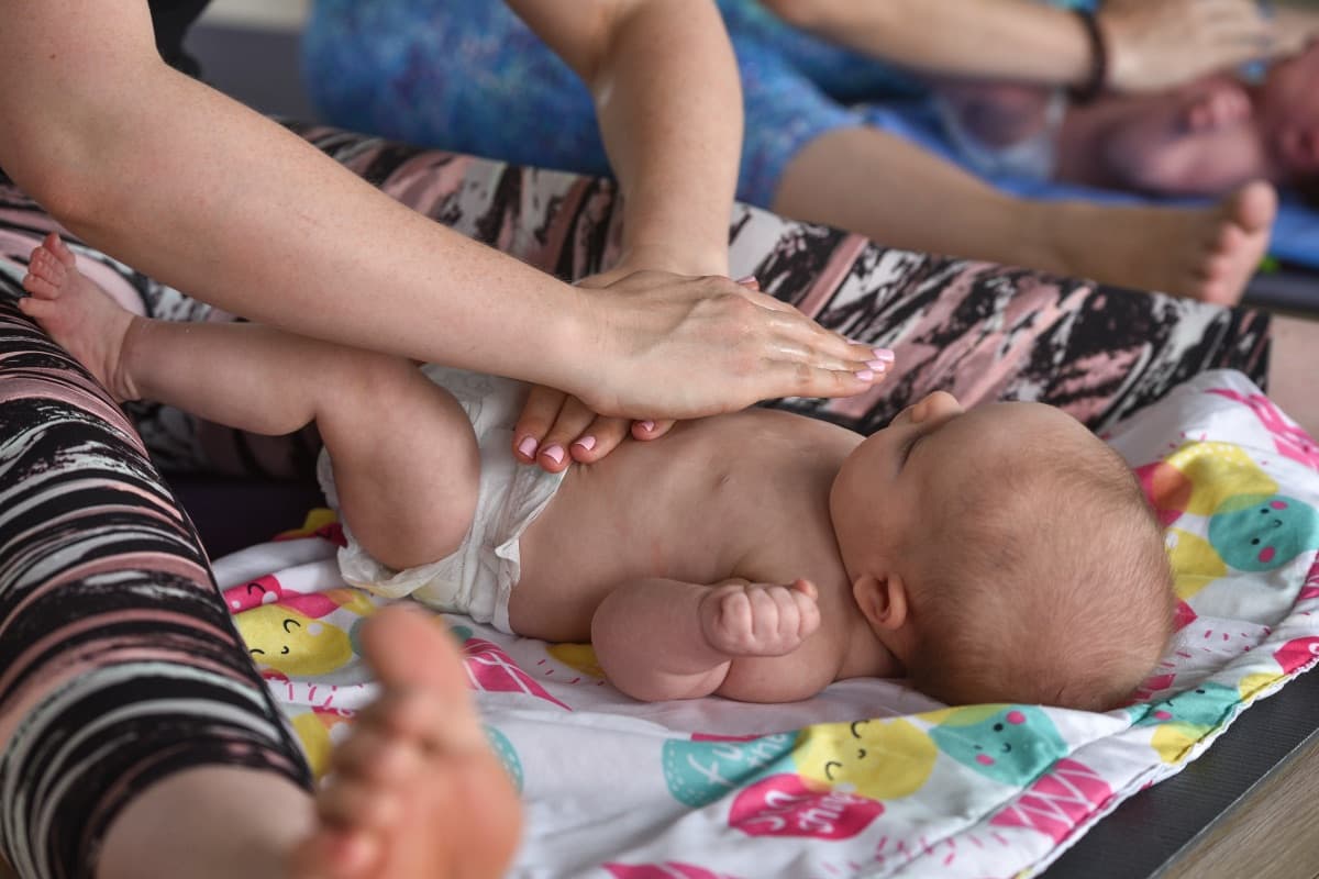 Parent gently massaging their baby during a Baby Massage workshop at Evolvere Lane Cove
