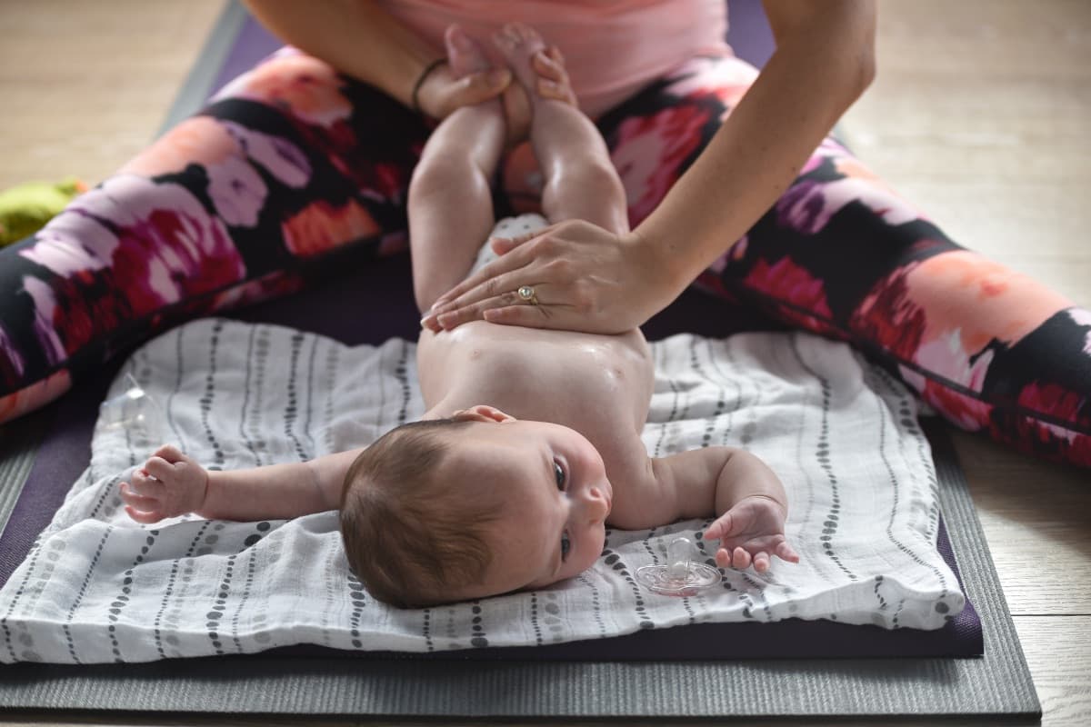 Parent learning infant massage techniques on their baby in Lane Cove