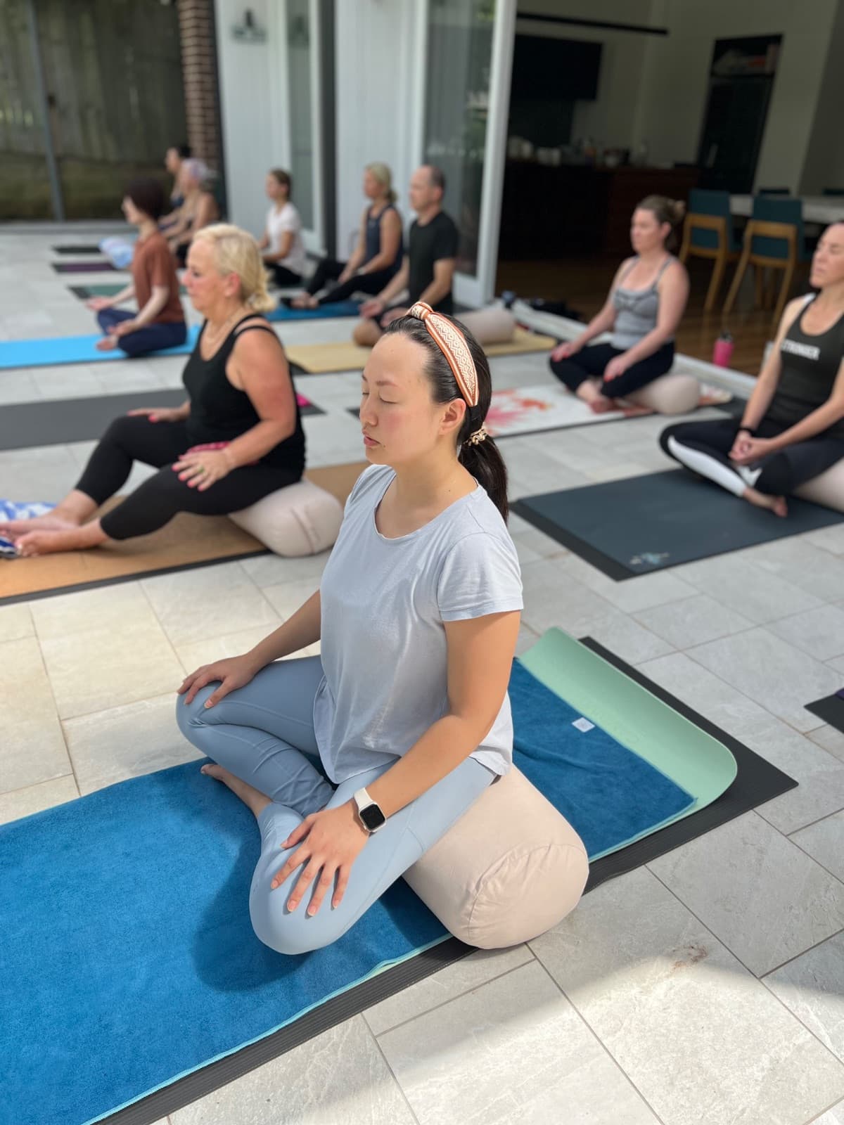 Group yoga practice in a peaceful studio setting at the retreat