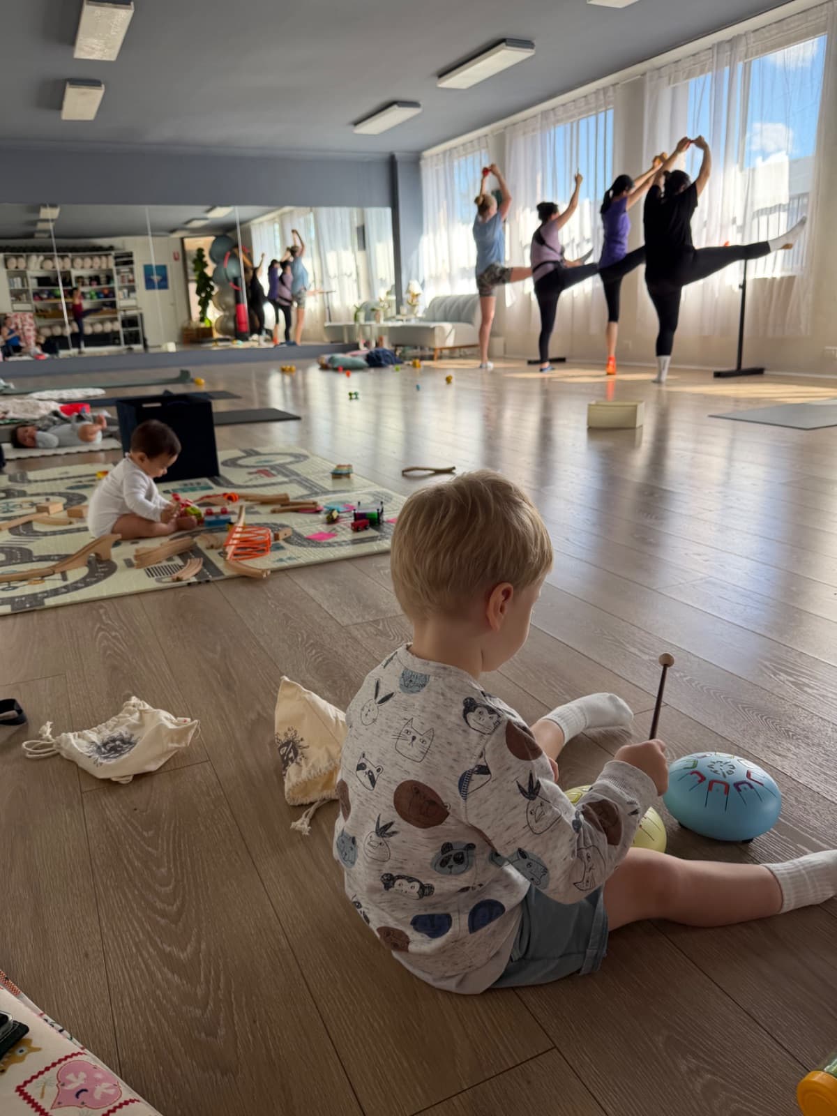New mums holding the barre during a postnatal mums and bubs barre workout