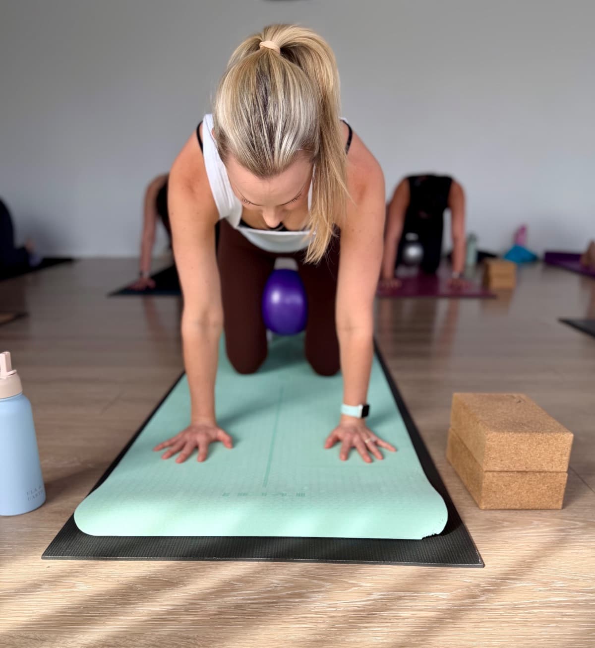 Postnatal pilates student doing pelvic floor and core activation exercises