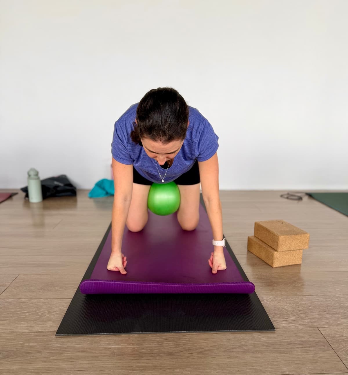Postnatal pilates class doing controlled leg exercises on mats
