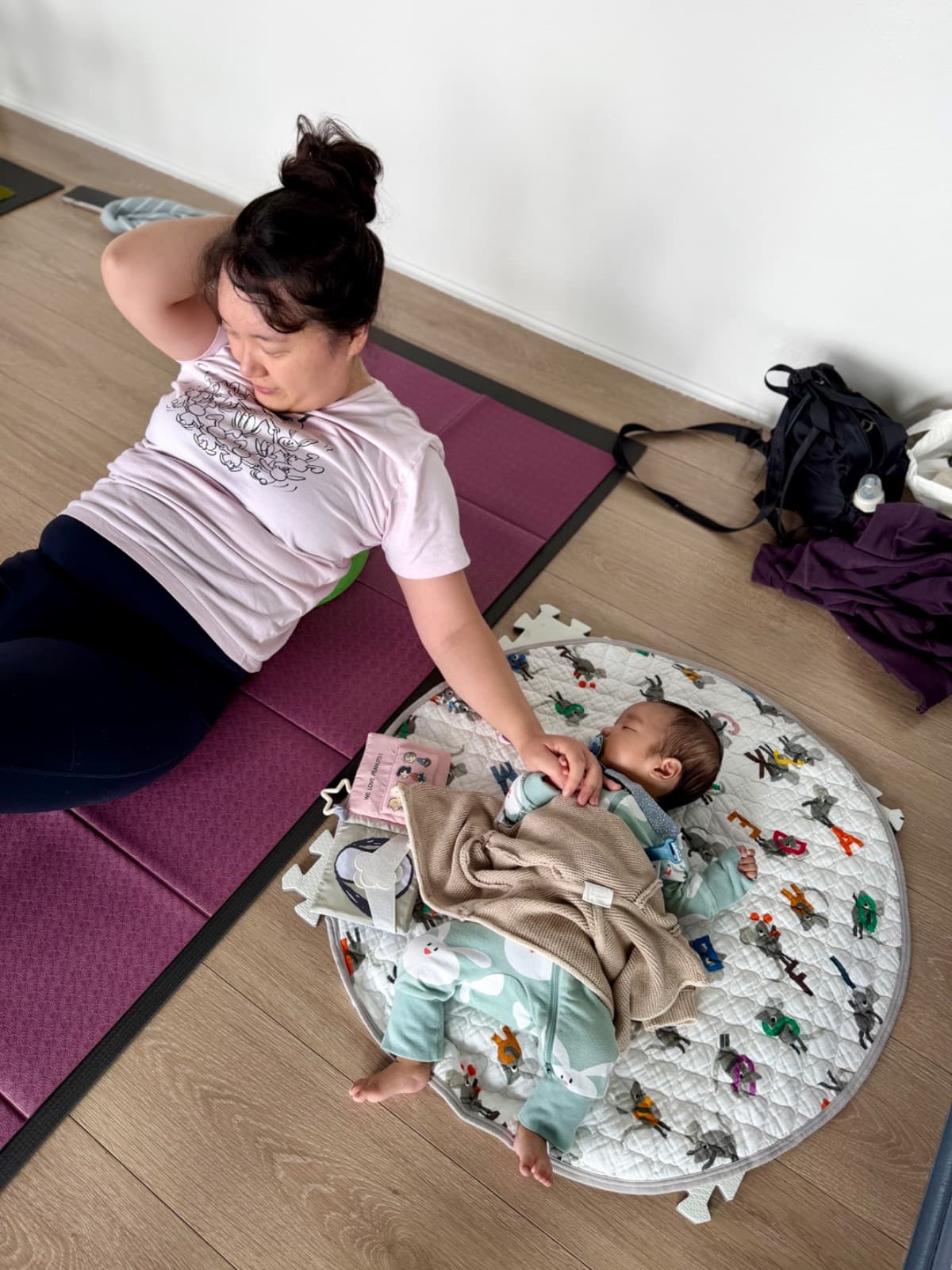 New mums holding the barre during a postnatal mums and bubs barre workout