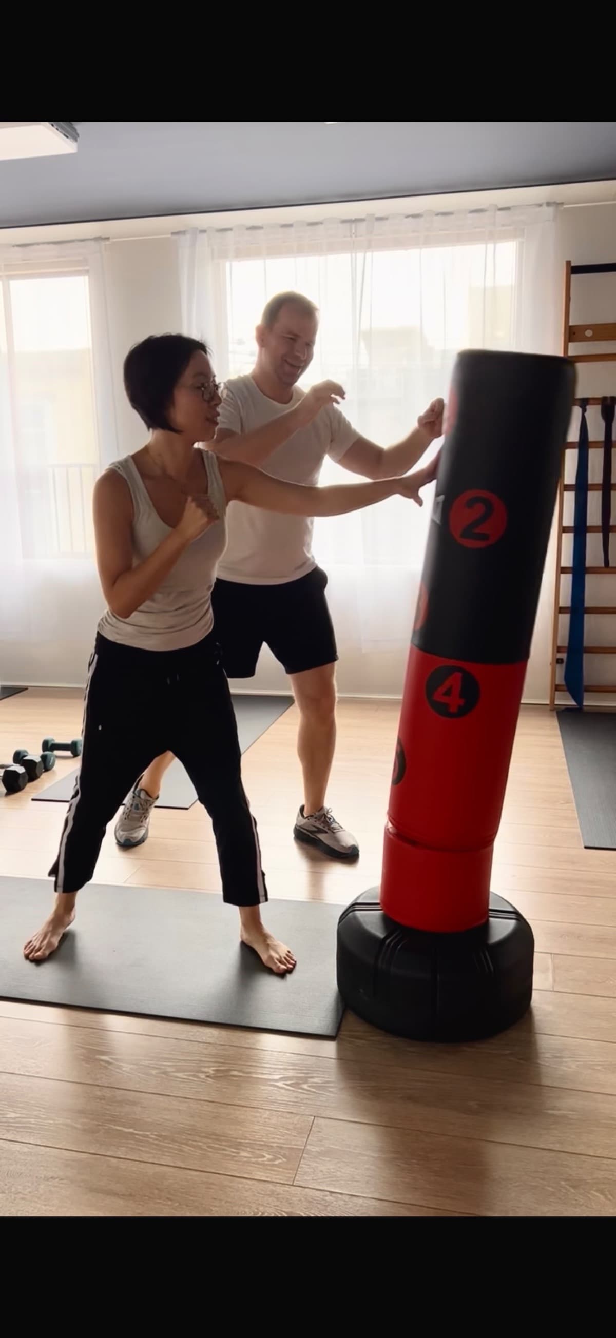 Student learning boxing technique on a freestanding punching bag at Evolvere